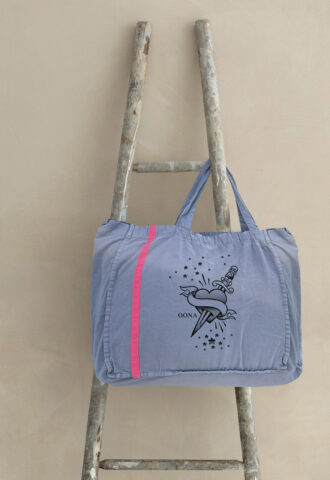 Graue Tasche mit Herz- und Dolchdesign auf Leiter.